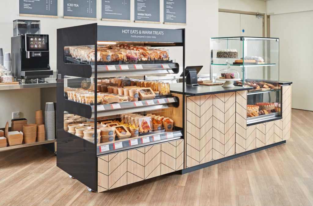 A large 3-tier Flexeserve Zone unit hot-holding a variety of foods at end of counter in a cafe