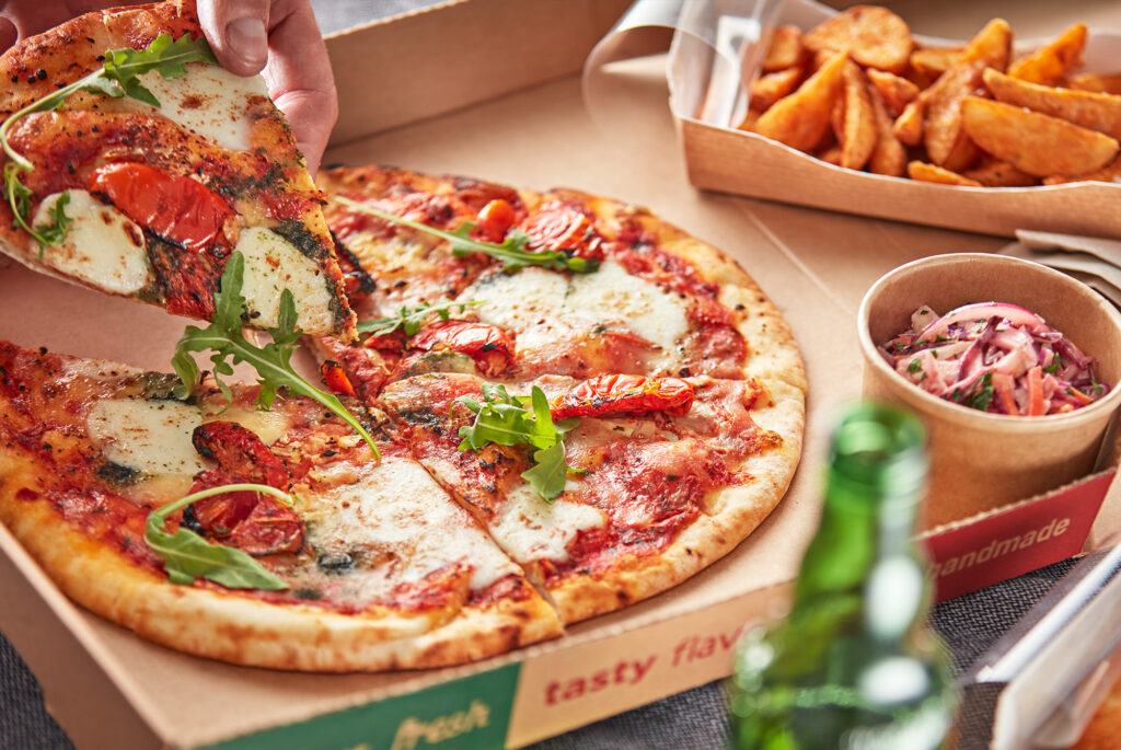 Pizza and potato wedges that have been served from a Flexeserve hot-holding unit