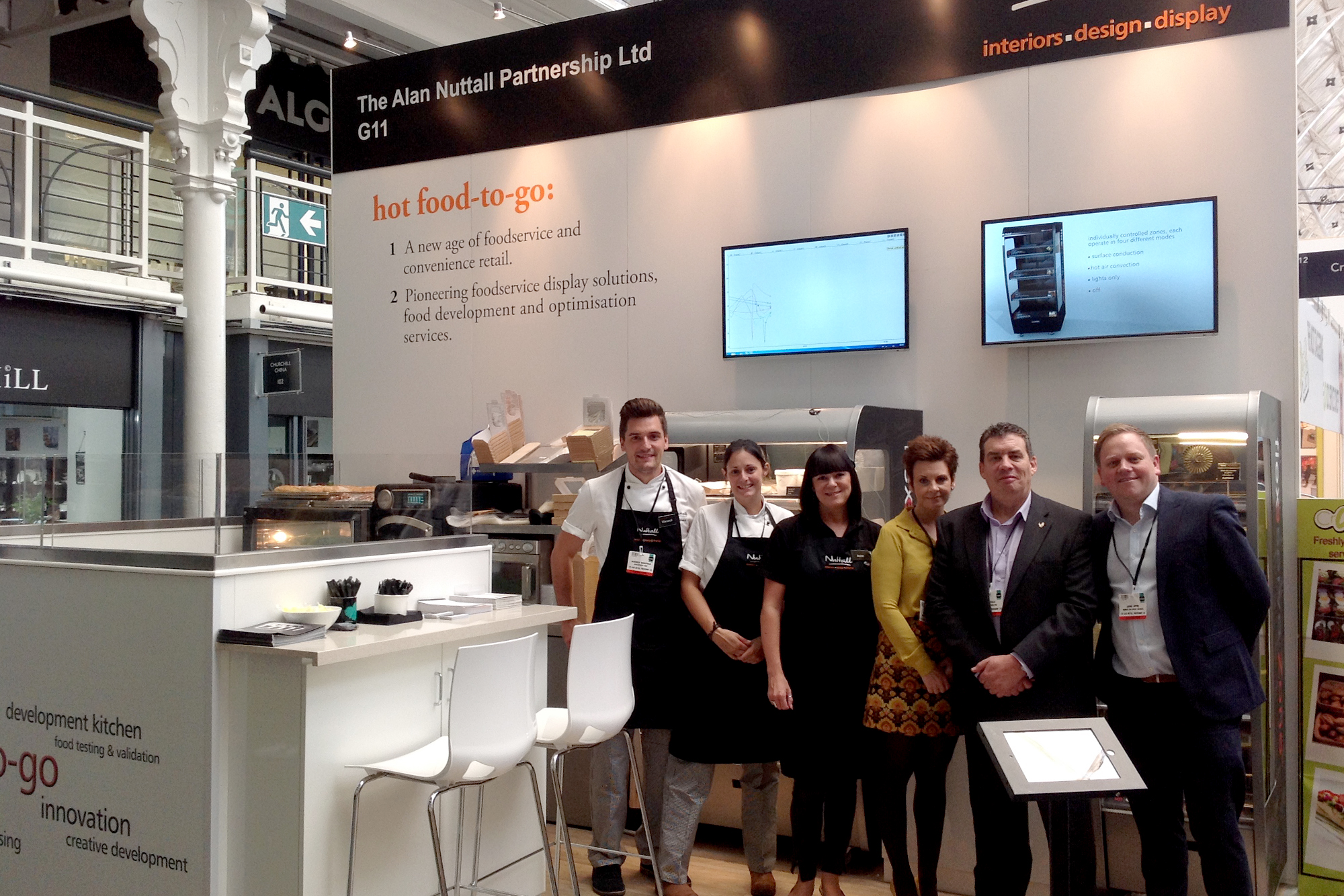 Flexeserve's Mick Steele pictured next to Jamie Joyce, Global CEO (far right) and Warwick Wakefield, Director of Customer Experience (far left) at the lunch! Show 2015 with early Flexeserve Zone products