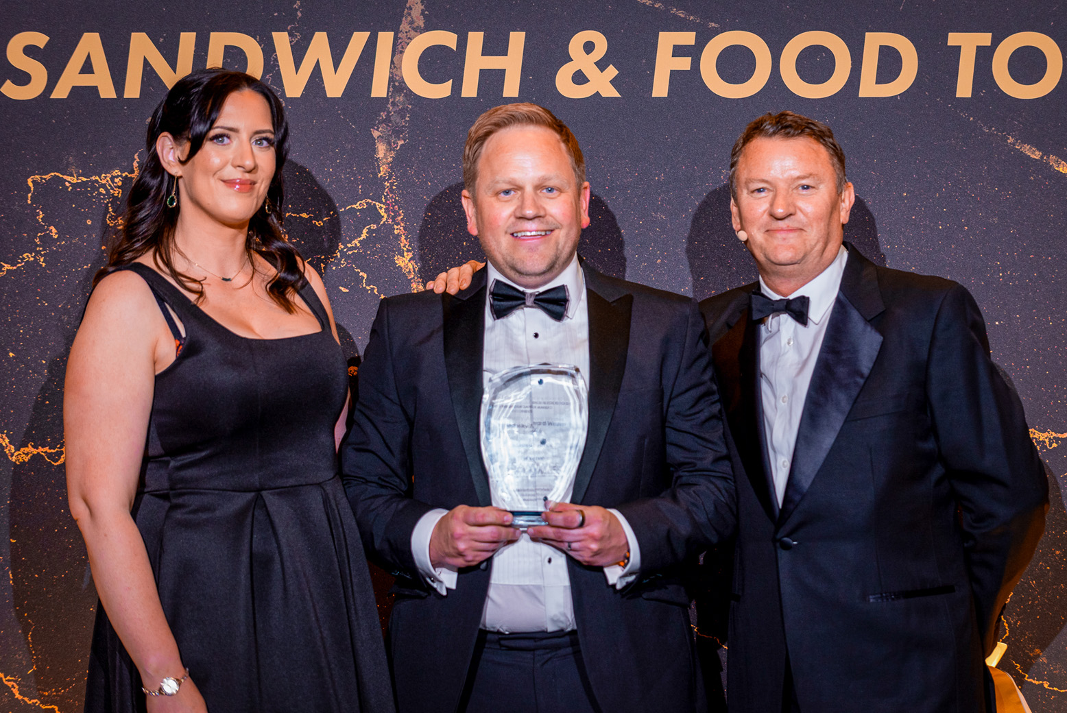 Flexeserve's Global CEO, Jamie Joyce, receives the Industry Award at The Sammies 2026 next to Jude Walker, Vice President, The BSA and Chef Theo Randall